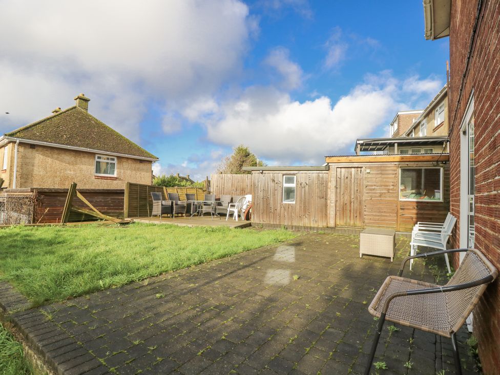 A garden with a patio and chairs at Red Brick Haven in East Cowes, Isle Of Wight