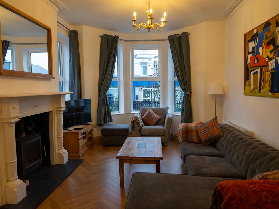 A living room with a sofa and a television at The Red Door in 