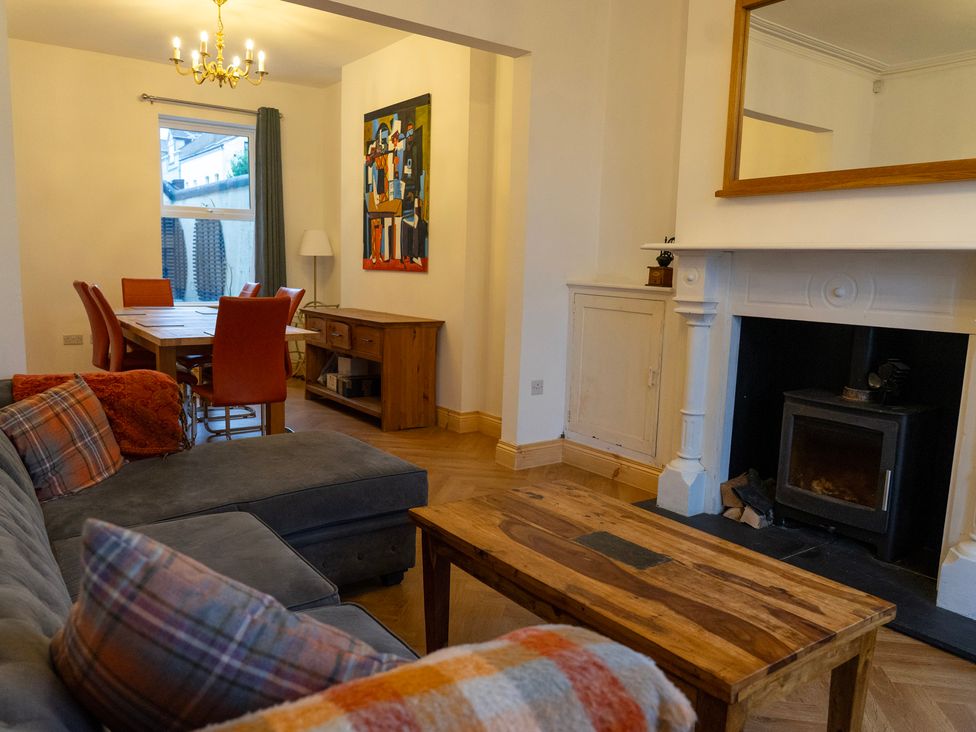 A living room with a fireplace and dining area at The Red Door