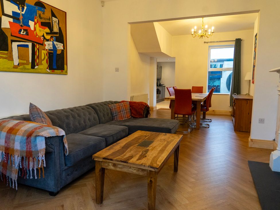A living room with a sofa and dining area at The Red Door in 