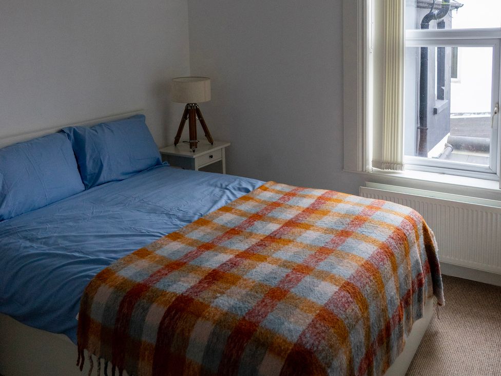 A bedroom with a bed and window at The Red Door in 