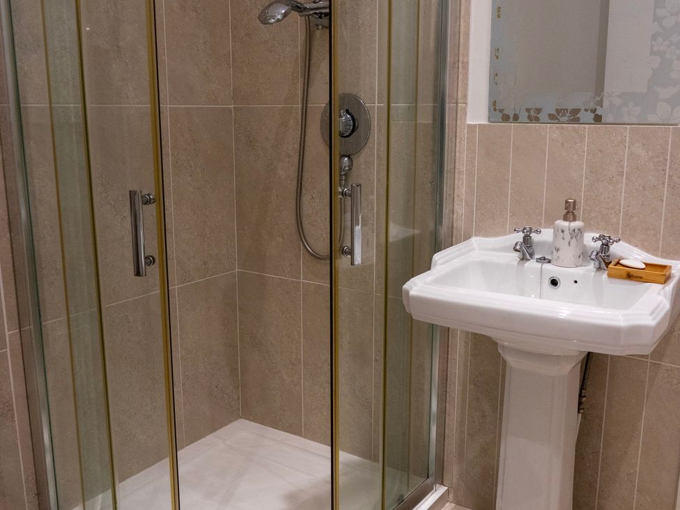 A bathroom with a shower and sink at The Red Door 