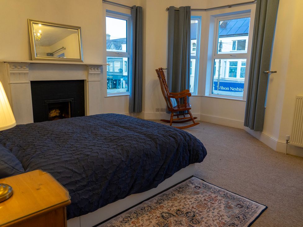 A bedroom with a bed and rocking chair at The Red Door 
