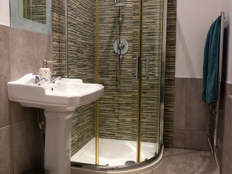 A bathroom with a sink and a shower enclosure at The Red Door in 