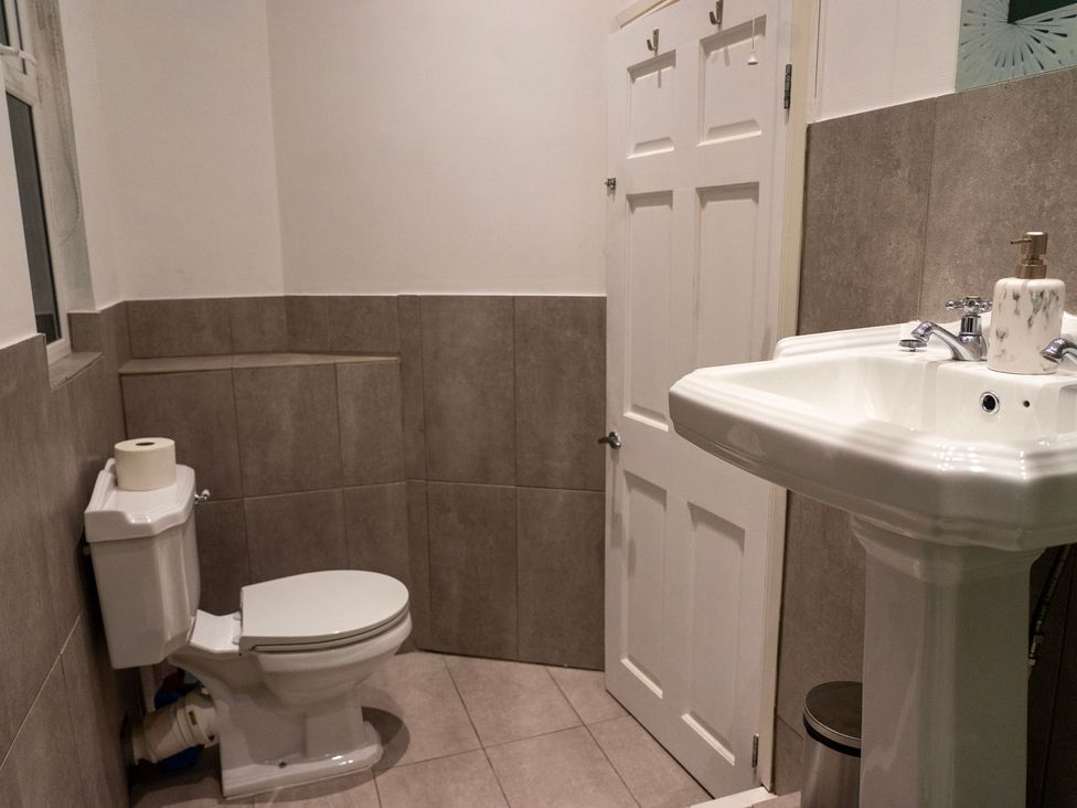 A bathroom with a toilet and sink at The Red Door