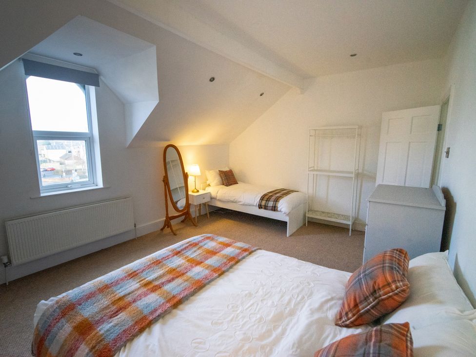 A bedroom with a bed and mirror at The Red Door in Bangor