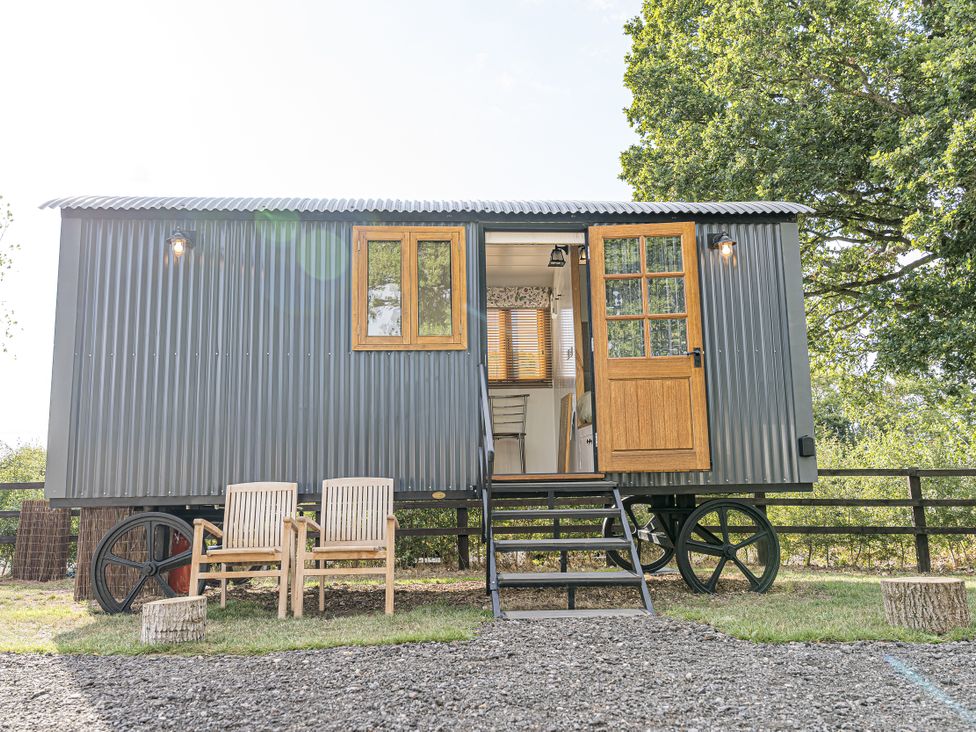 A mobile home with steps and chairs outside at No 2 The Parkland Upton Warren