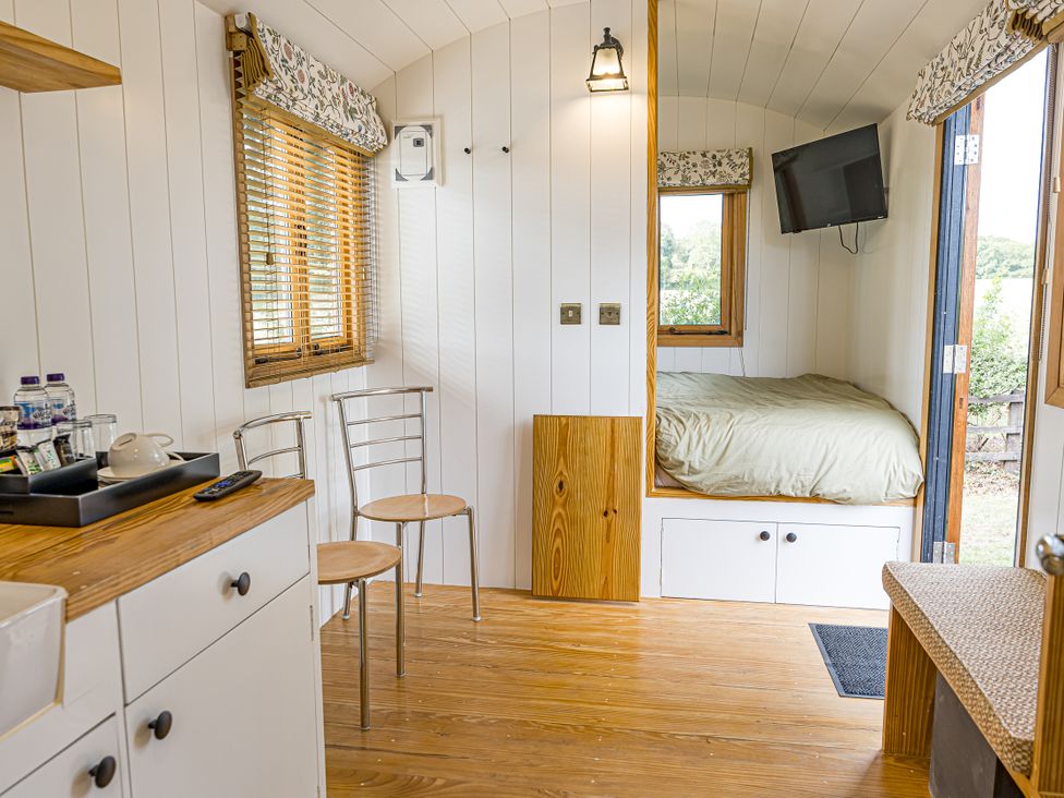 A bedroom with a bed and chair at No 2 The Parkland Upton Warren