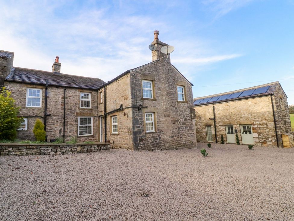 A stone house with satellite dish and gravel driveway at Cowside Farm in Langcliffe near Settle