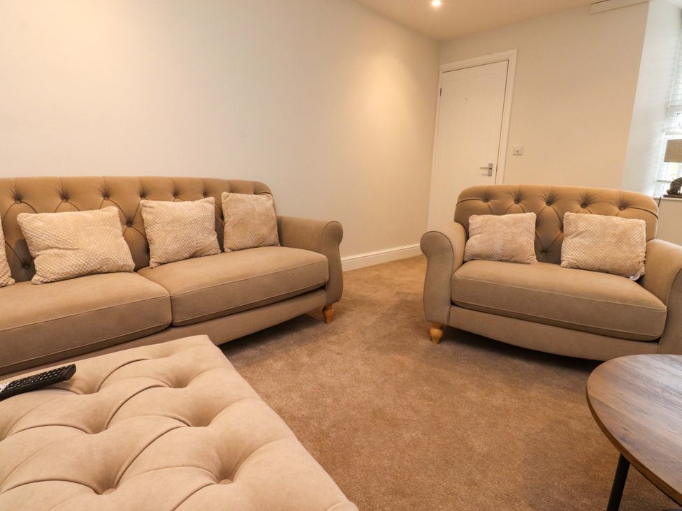 A living room with sofas and a coffee table at Cowside Farm in Langcliffe near Settle