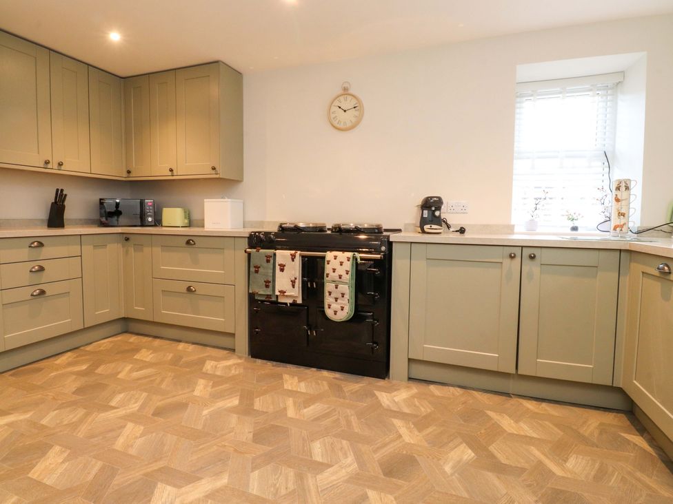 A kitchen with cabinets and a cooker at Cowside Farm in Langcliffe near Settle