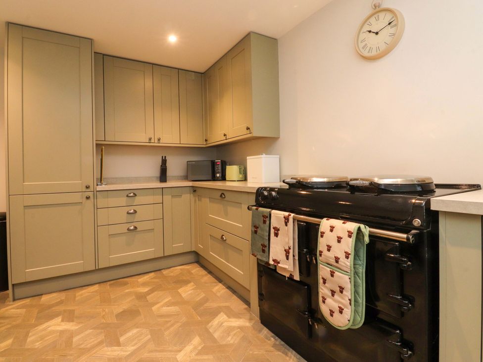 A kitchen with cabinets and a stove at Cowside Farm in Langcliffe near Settle