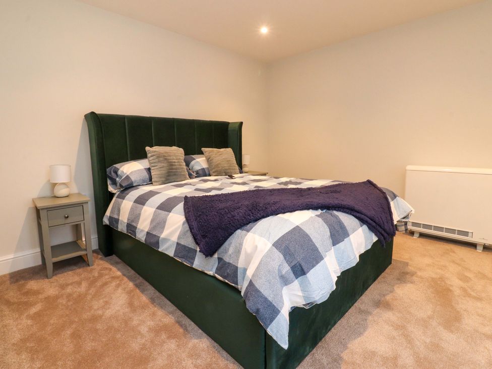 A bedroom with a bed and nightstand at Cowside Farm in Langcliffe near Settle