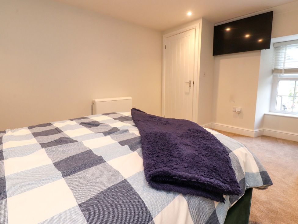 A bedroom with a bed and TV at Cowside Farm in Langcliffe near Settle