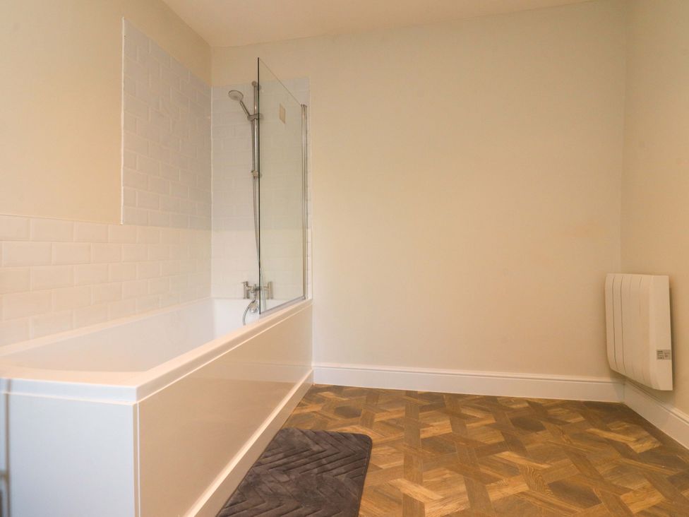 A bathroom with a bathtub and shower at Cowside Farm in Langcliffe near Settle