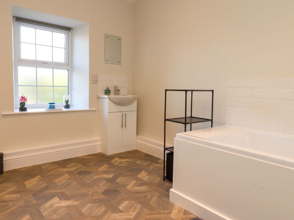 A bathroom with a bathtub and sink at Cowside Farm in Langcliffe near Settle