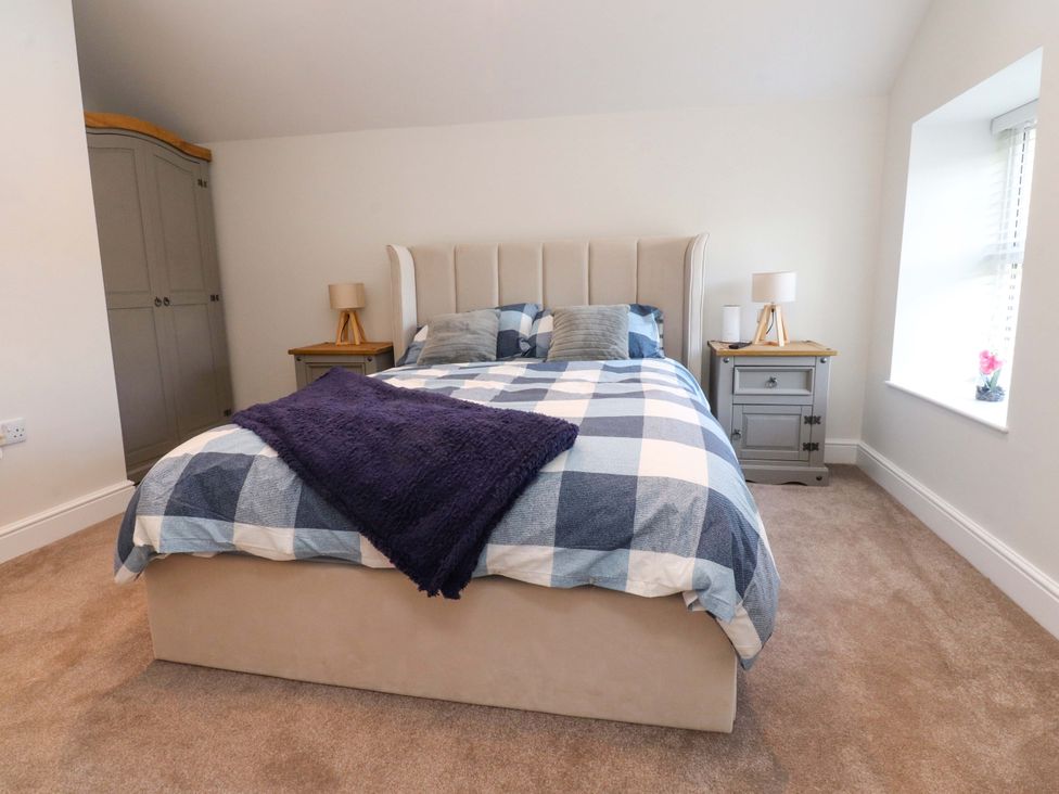A bedroom with a bed and bedside tables at Cowside Farm in Langcliffe near Settle
