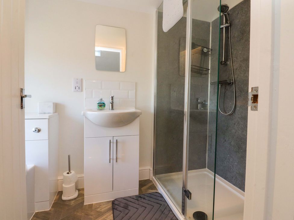 A bathroom with a shower and sink at Cowside Farm in Langcliffe near Settle
