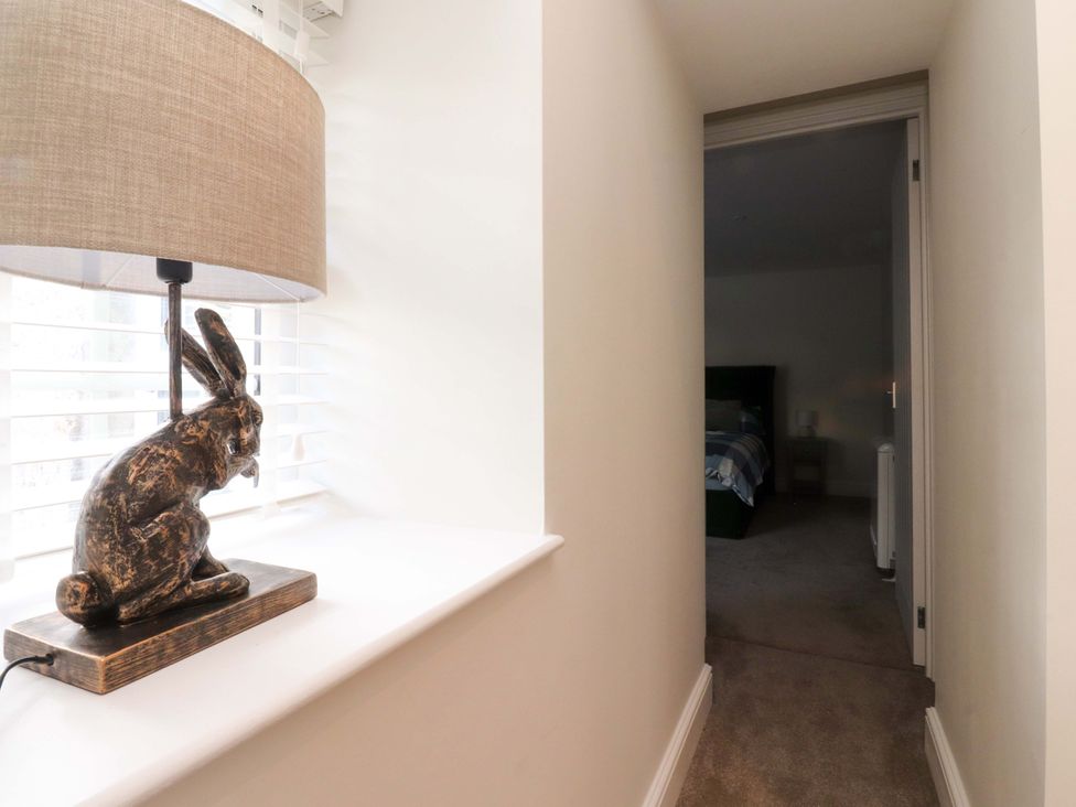 A hallway with a rabbit sculpture and lamp at Cowside Farm Langcliffe near Settle
