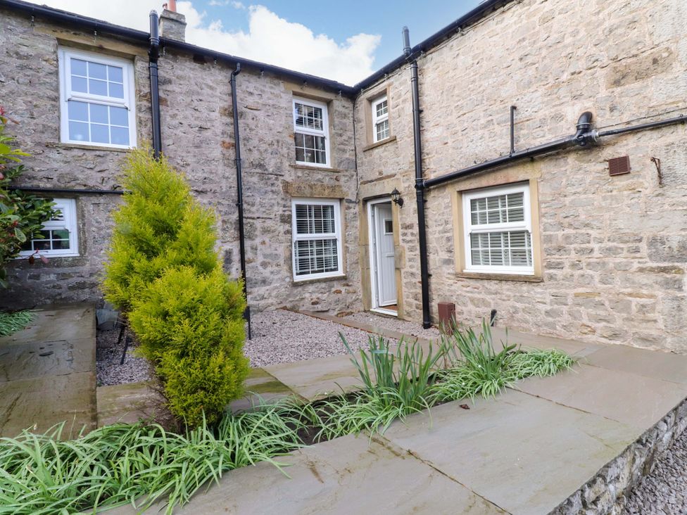 An outdoor area with stone walls and plants at Cowside Farm in Langcliffe near Settle