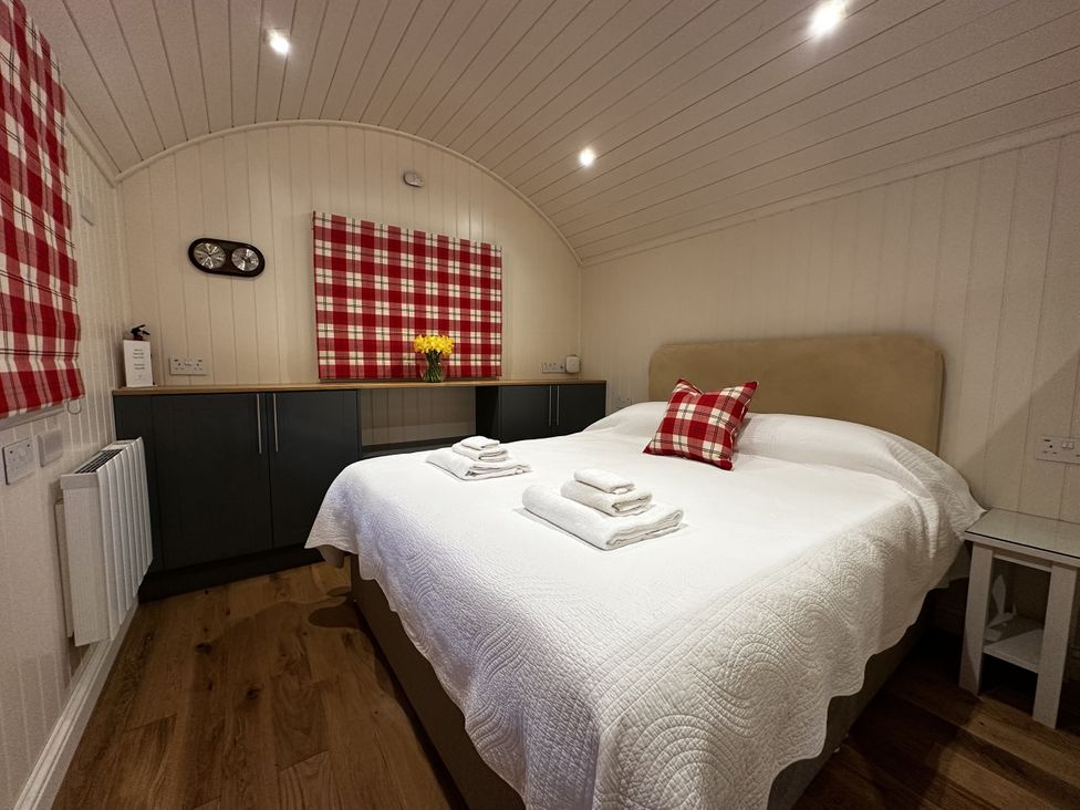 A bedroom with a bed and towels on it at The Lodge in Upton Warren