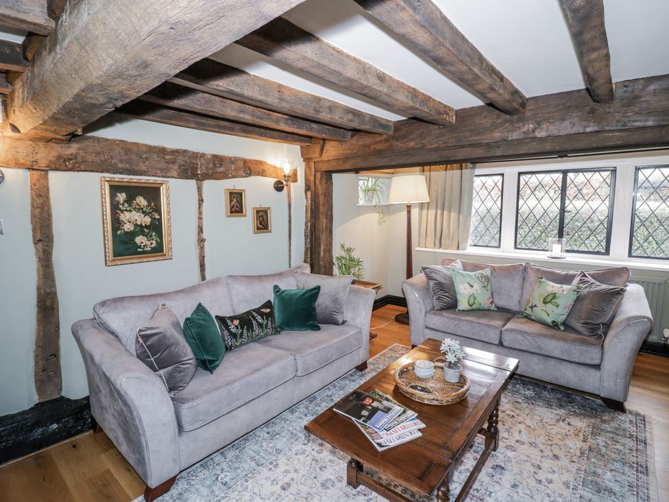 A living room with sofas and a coffee table at Weston Cottage Stratford-upon-Avon
