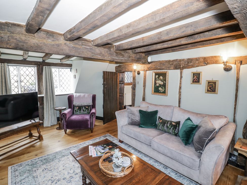 A living room with a sofa and armchair at Weston Cottage Stratford-upon-Avon