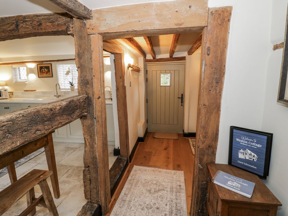 A hallway with wooden beams and door at Weston Cottage Stratford-upon-Avon