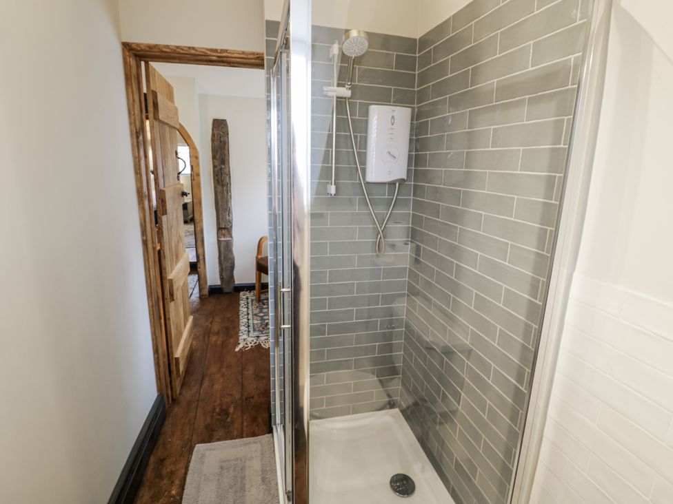 A shower with a glass door in a bathroom at Weston Cottage in Stratford-upon-Avon