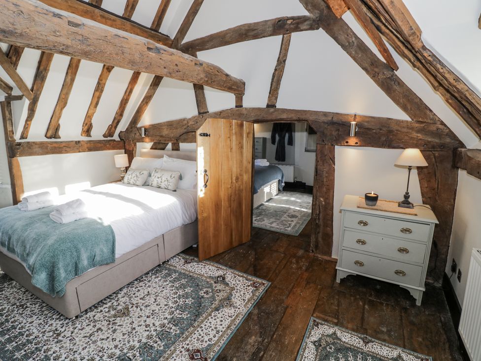 A bedroom with a bed and a dresser at Weston Cottage in Stratford-upon-Avon