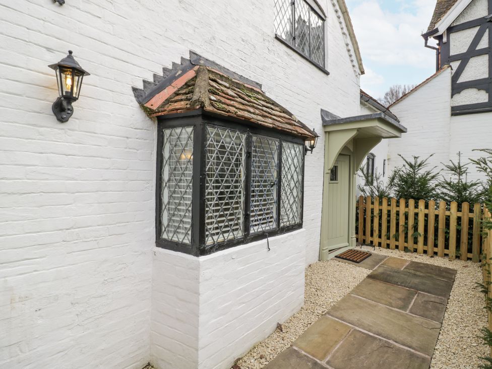 An exterior view showing a window, door, and pathway at Weston Cottage Stratford-upon-Avon
