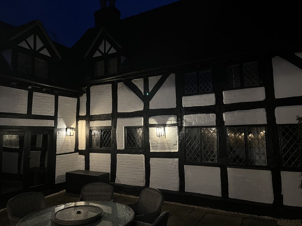 An outdoor seating area beside a house at Weston Cottage in Stratford-upon-Avon