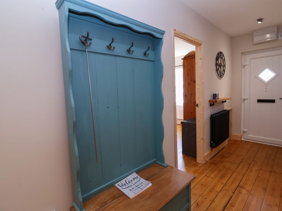 A hallway with a coat rack and welcome mat at 1 Ashcott Place Burnham-On-Sea