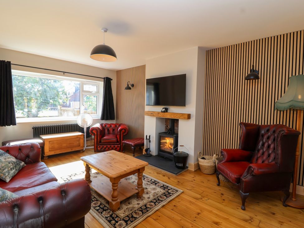 A living room with a sofa, armchairs and a fireplace at 1 Ashcott Place Burnham-On-Sea