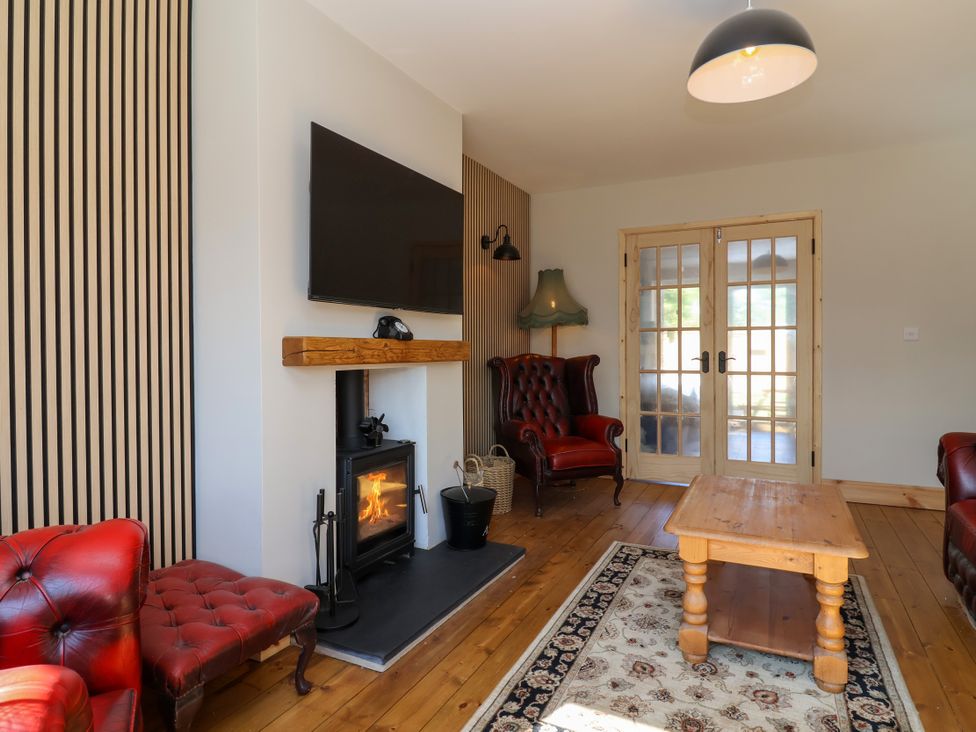 A living room with a fireplace and coffee table at 1 Ashcott Place Burnham-On-Sea