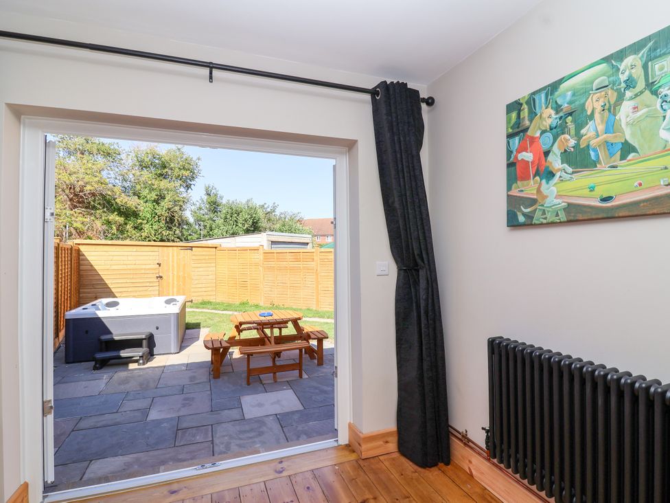 An indoor view with a hot tub and picnic table in the garden at 1 Ashcott Place Burnham-On-Sea