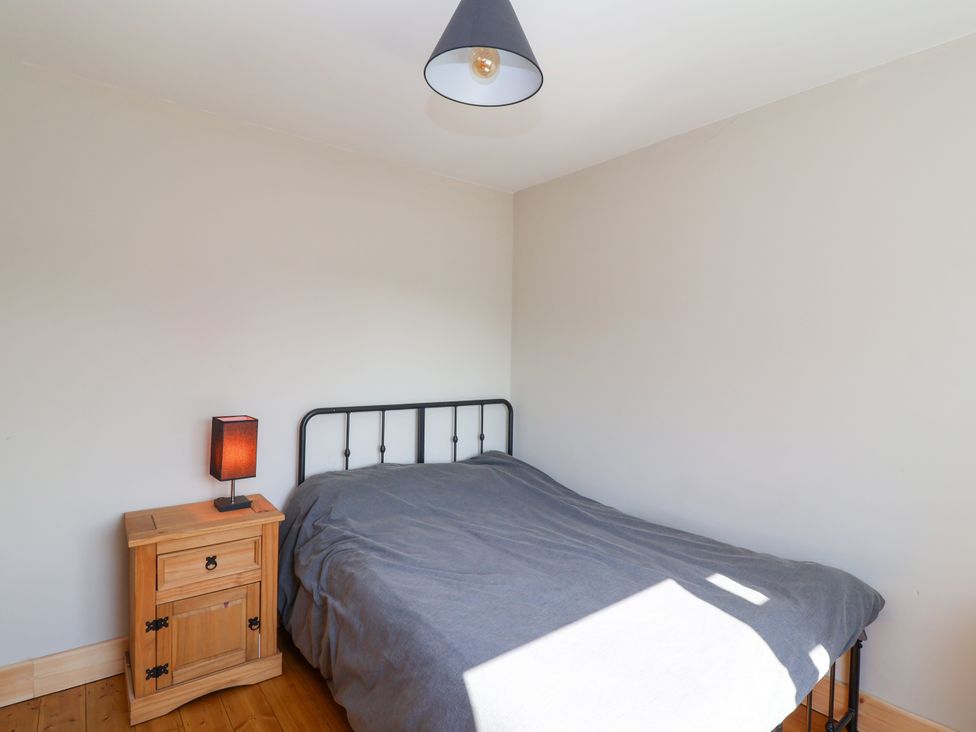 A bedroom with a bed and bedside table at 1 Ashcott Place in Burnham-On-Sea