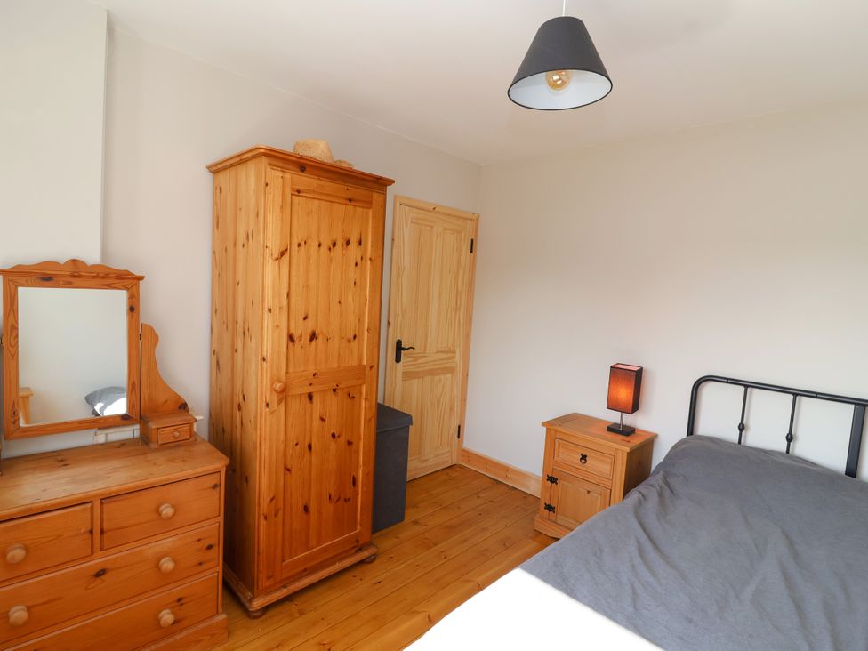 A bedroom with a wardrobe and a lamp at 1 Ashcott Place Burnham-On-Sea