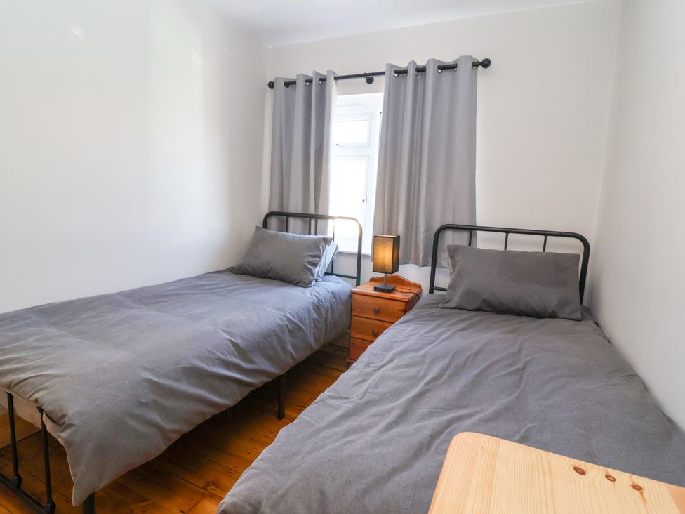 A bedroom with two beds and a window at 1 Ashcott Place in Burnham-On-Sea