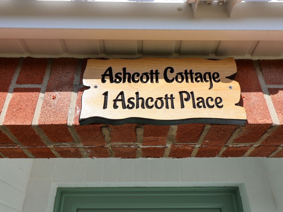 A sign displaying Ashcott Cottage at 1 Ashcott Place in Burnham-On-Sea