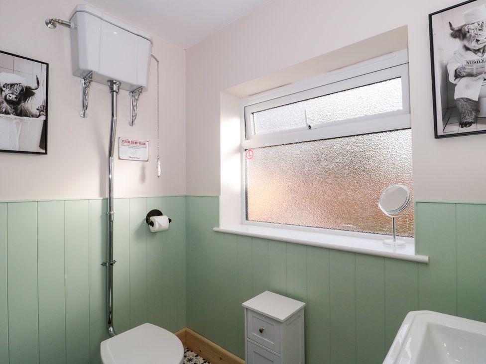 A bathroom with a toilet and sink at 1 Ashcott Place Burnham-On-Sea
