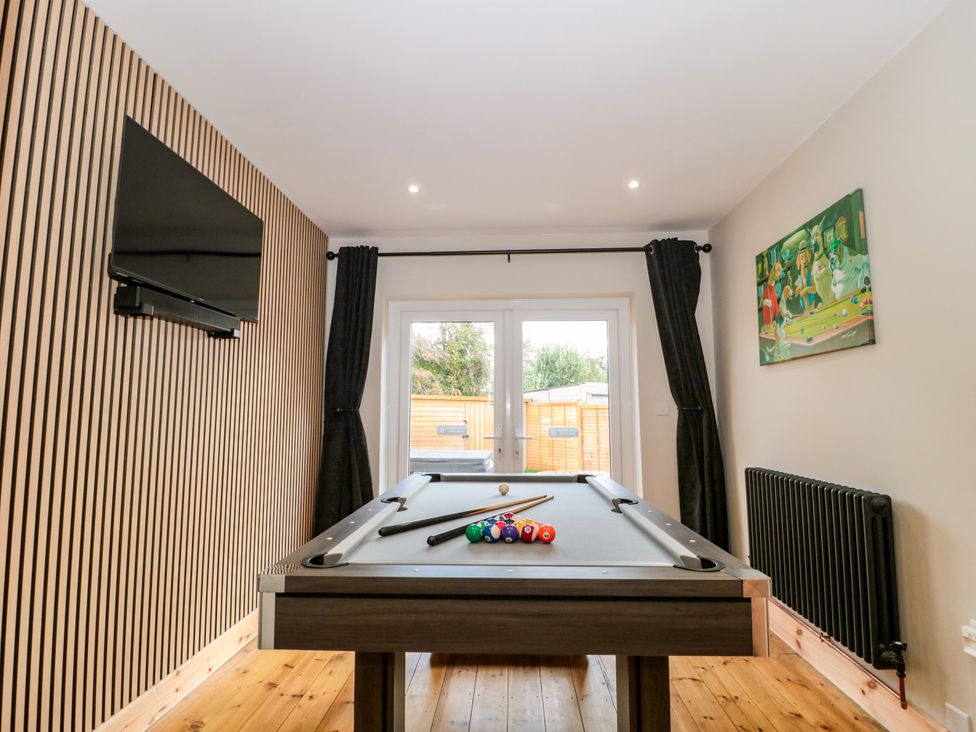 A games room with a pool table and television at 1 Ashcott Place Burnham-On-Sea
