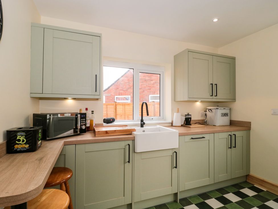 A kitchen with cabinets and a sink at 1 Ashcott Place Burnham-On-Sea