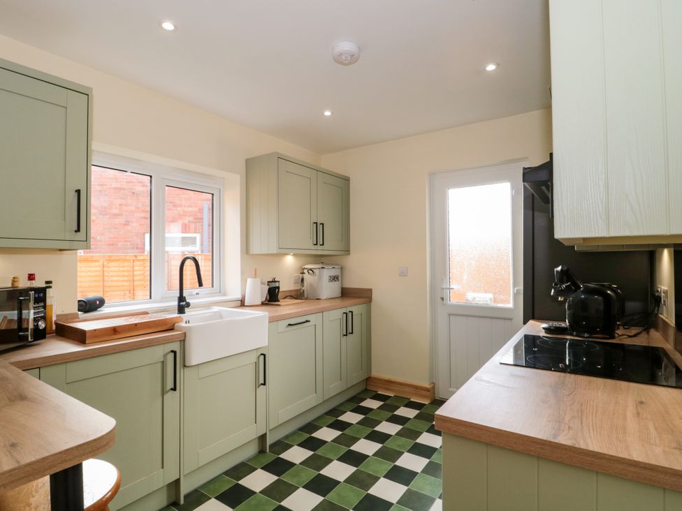 A kitchen with a sink and appliances at 1 Ashcott Place Burnham-On-Sea
