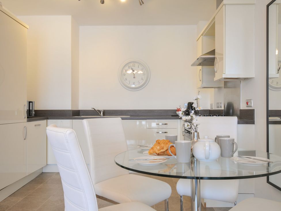 A kitchen with a table set for breakfast at Sea Snug in Newquay