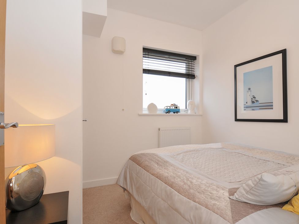 A bedroom with a bed and a lamp at Sea Snug in Newquay