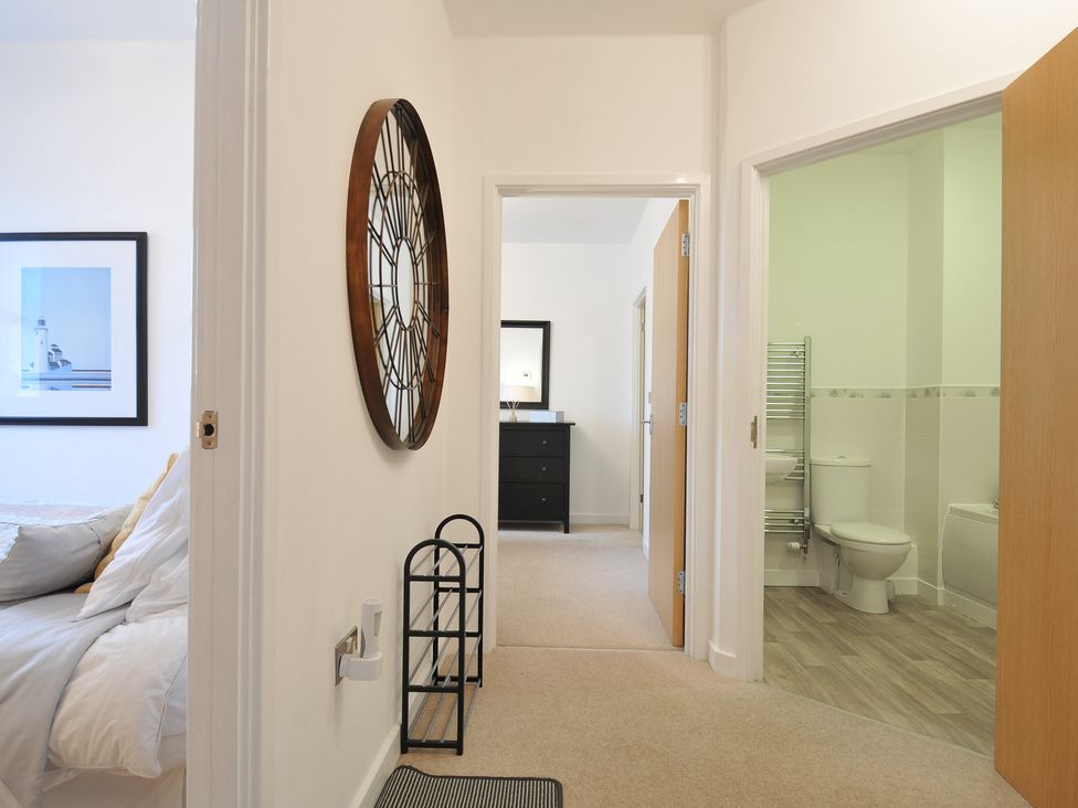 A hallway leading to a bathroom and bedroom at Sea Snug in Newquay