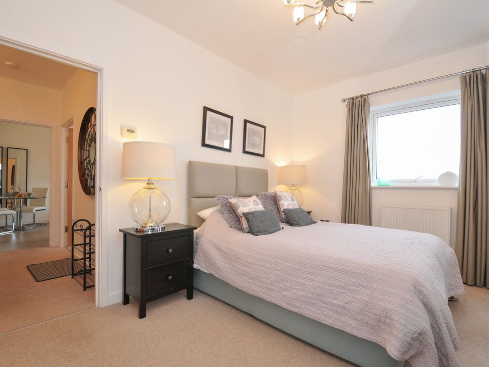 A bedroom with a bed and lamp at Sea Snug in Newquay