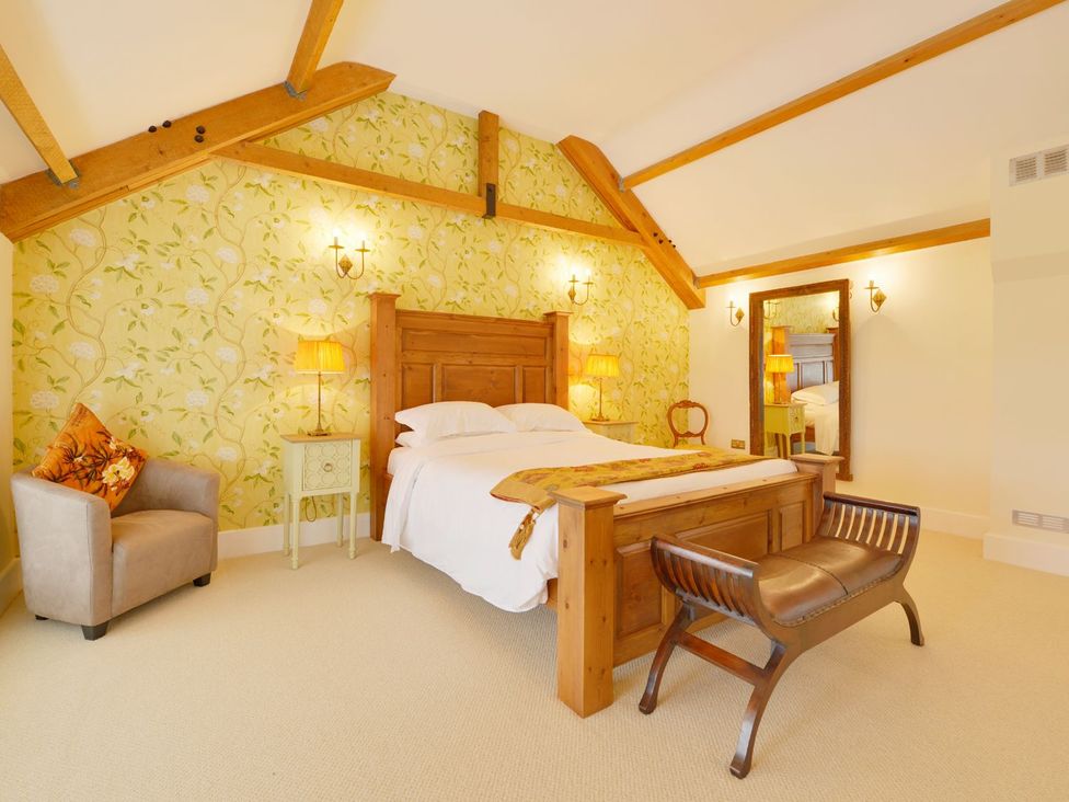 A bedroom with a bed and furniture at The Cider Barn at Home Farm Down Thomas near Wembury