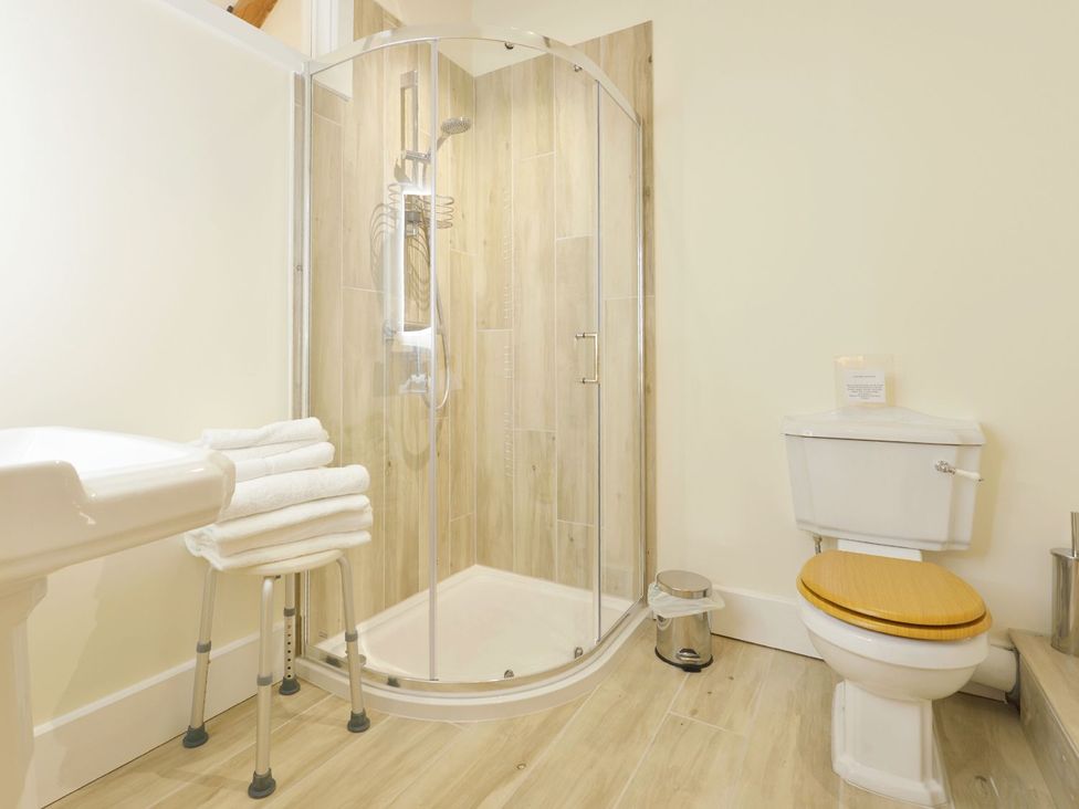 A bathroom with a shower and toilet at The Cider Barn at Home Farm Down Thomas near Wembury